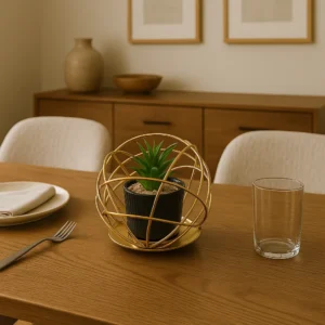 Golden orb planter centerpiece with artificial plant on dining table